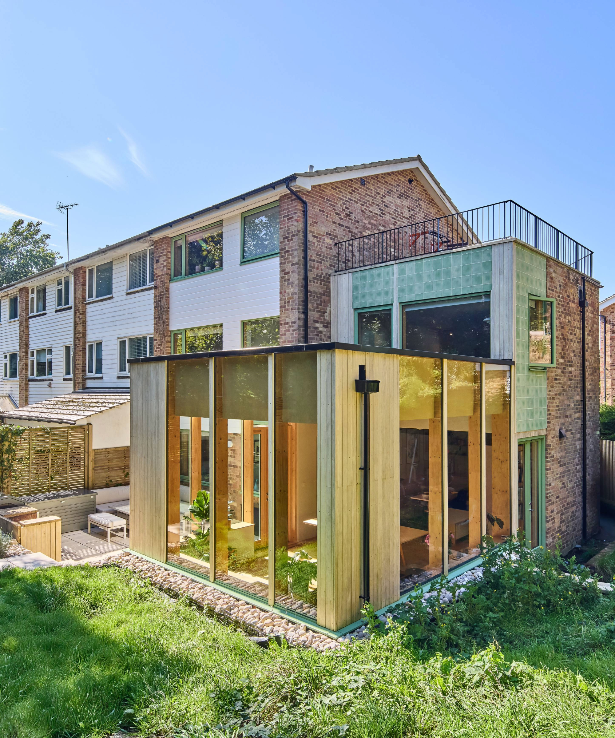 Back exterior of the house, with focus on the side extension and terrace