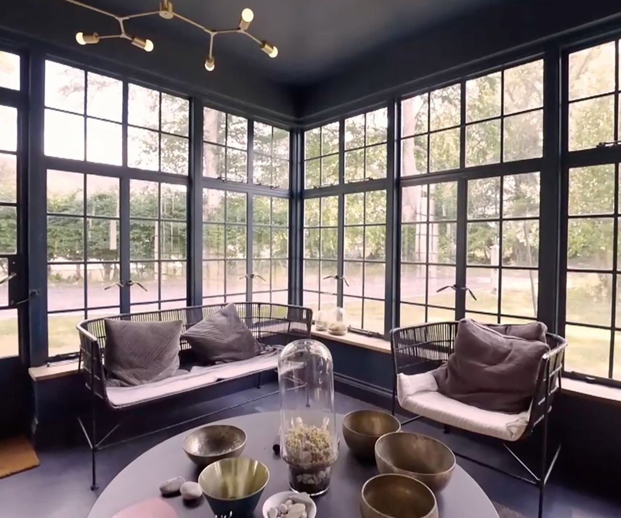 A black roofed conservatory and sitting room with a black uPVC door