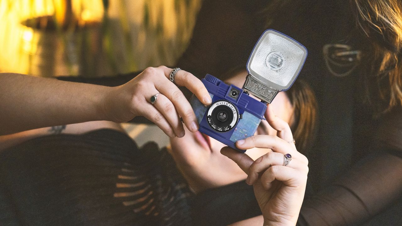 The Lomography Half-Frame Lomourette held over a person's face