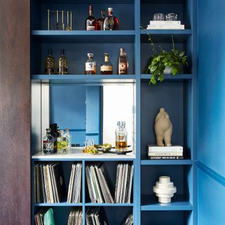 blue shelving unit with books and drink bottles