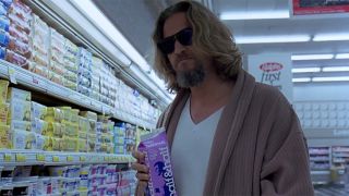Jeff Bridges in a bathrobe, a white tee and sandals inside a grocery store in The Big Lebowski. He is also wearing sunglasses inside.