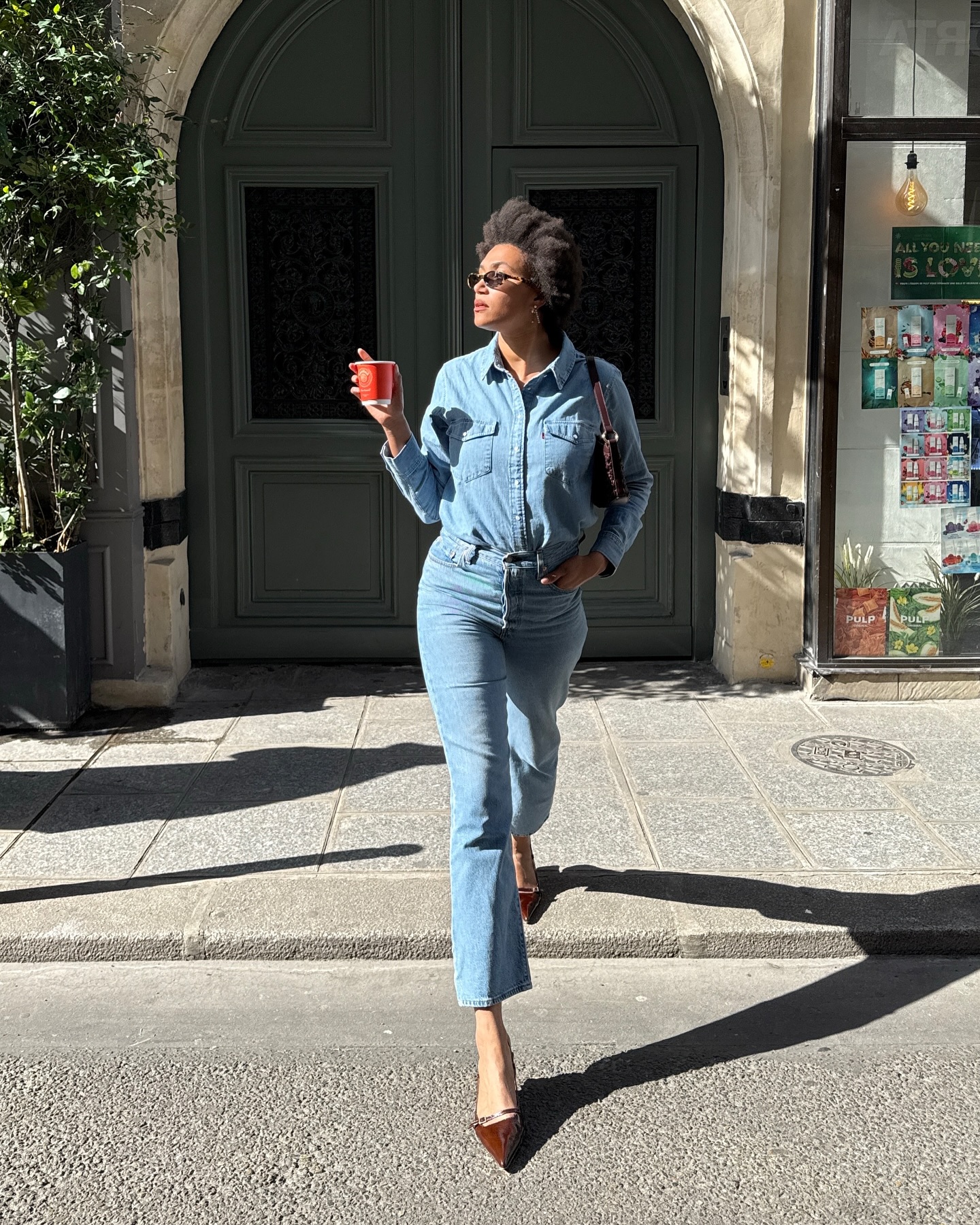 A French woman wearing cropped flares and heels.