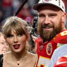 Taylor Swift has bangs and wears bright red lipstick while Travis Kelce wears a baseball cap following the NFL Super Bowl 58 football game between the San Francisco 49ers and the Kansas City Chiefs at Allegiant Stadium on February 11, 2024