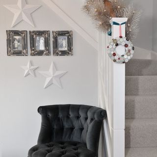 hallway with staircase and velvet tub chair