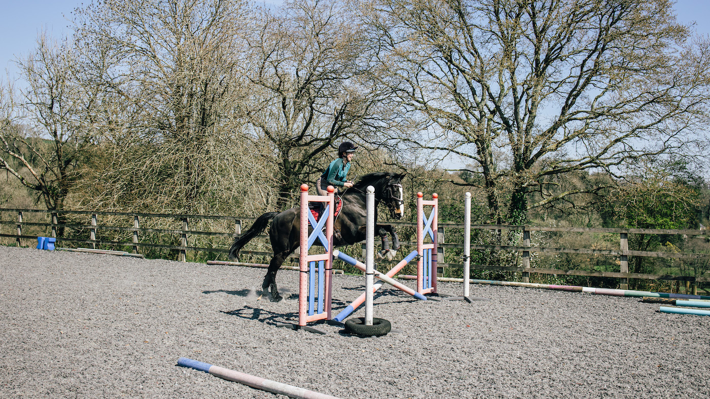 Rider jumping cross-pole fence
