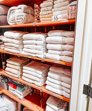 entryway organized linen closet with plastic dividers