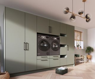 bank of green floor to ceiling cupboards with built in washer and dryer