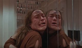 A dancer being thrown up against the mirrors in Suspiria
