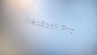 The MacBook Pro 2021 (14-inch)'s etched/debossed branding on the underside