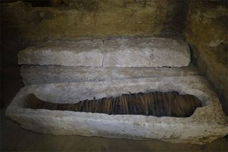 A mummy found in an opened stone sarcophagus is still bandaged and does not seem to have been disturbed since it was buried around 2,500 years ago. The mummy is likely that of one of the high priests or their assistants.