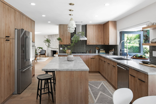 A neutral modern kitchen with light wooden cabinetry