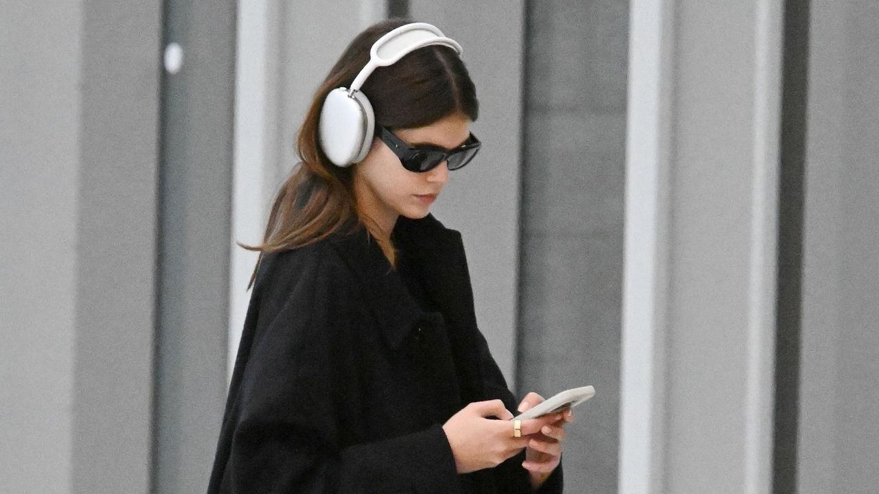 Kaia gerber at the airport wearing a black coat