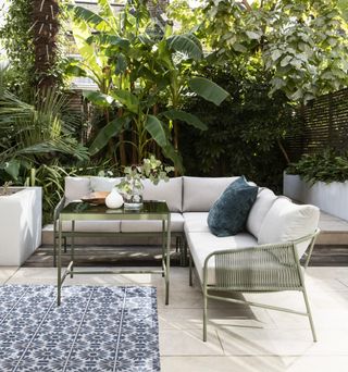 Modern outdoor sofa with colourful cushions on a patio