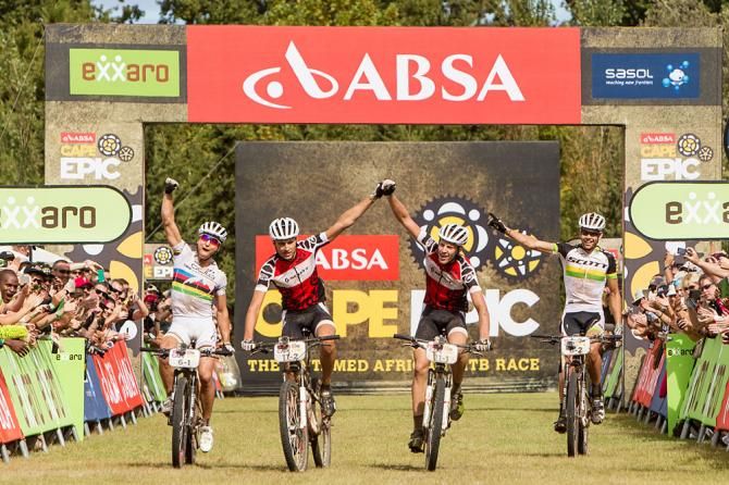 All African Jersey holders Gert Heyns (centre left) and Matthys Beukes (centre right) of SCOTT Factory Racing celebrate winning the final stage as Nino Schurter (far left) and Philip Buys (far right) of Scott-Odlo MTB Racing celebrate finishing second during the final stage