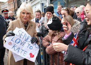 Queen Camilla receives a message of support for Catherine, Princess of Wales from well-wishers during her visit to the Farmers' Market on March 27, 2024 in Shrewsbury, England.