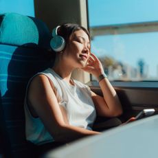 railcard deals - woman on the train listening to music 1774783070