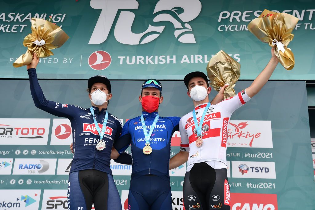KEMER TURKEY APRIL 14 Podium Jasper Philipsen of Belgium and Team AlpecinFenix 2nd Classified Mark Cavendish of United Kingdom and Team Deceuninck QuickStep 1st Classified Stanislaw Aniolkowski of Poland and Team Bingoal WB 3rd Classified Celebration during the 56th Presidential Cycling Tour Of Turkey 2021 Stage 4 a 1844km stage from Alanya to Kemer Mask Covid safety measures Flowers TUR2021 tourofturkeyTUR on April 14 2021 in Kemer Turkey Photo by Stuart FranklinGetty Images
