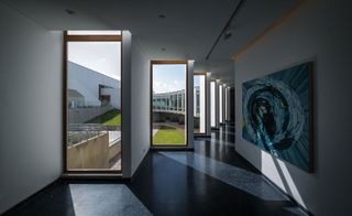 Hallway with large windows & wall art