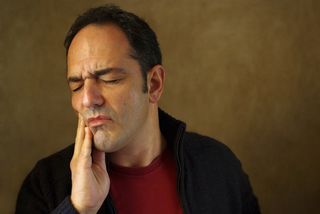 man in pain with a toothache