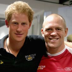 Prince Harry wears a black polo shirt and Mike Tindall wears a red soccer jersey while attending the Invictus Games 2014