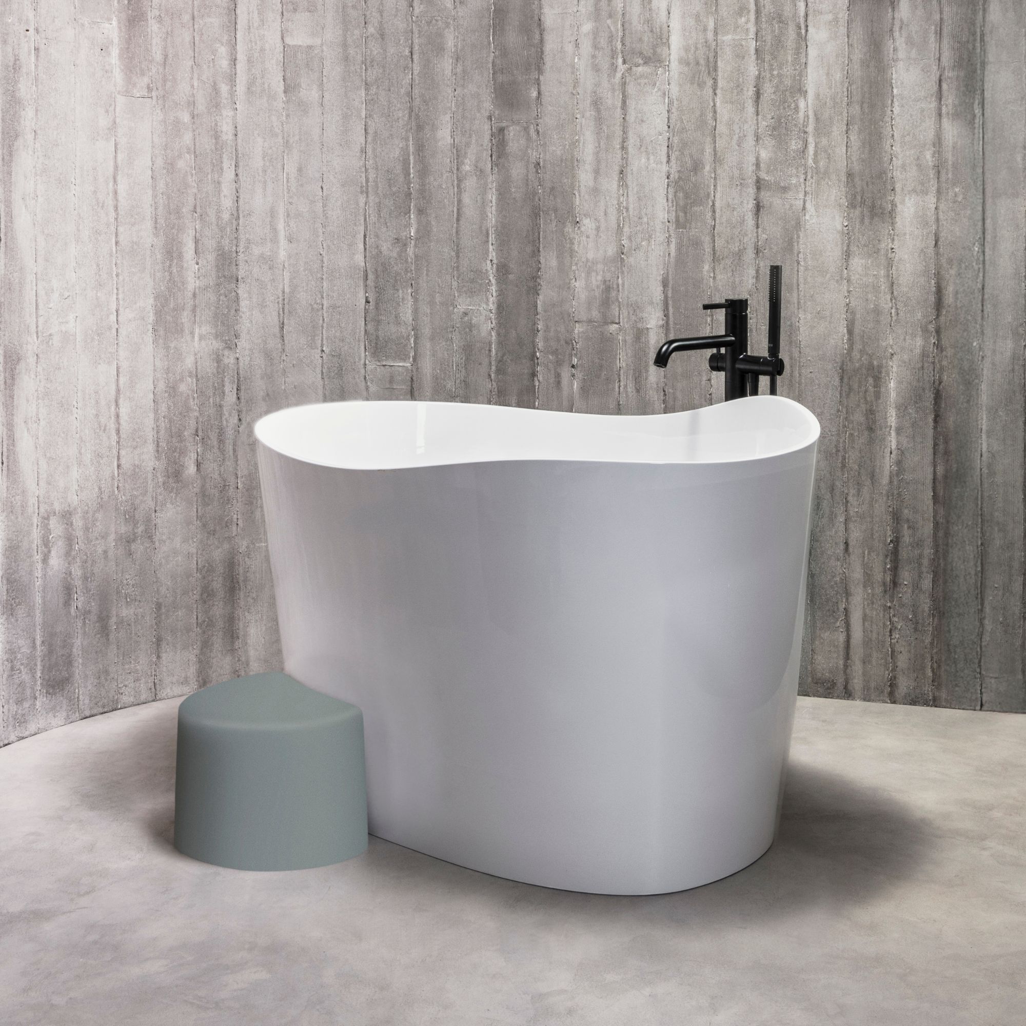 An Ofuro-inspired bath tub against a wooden wall