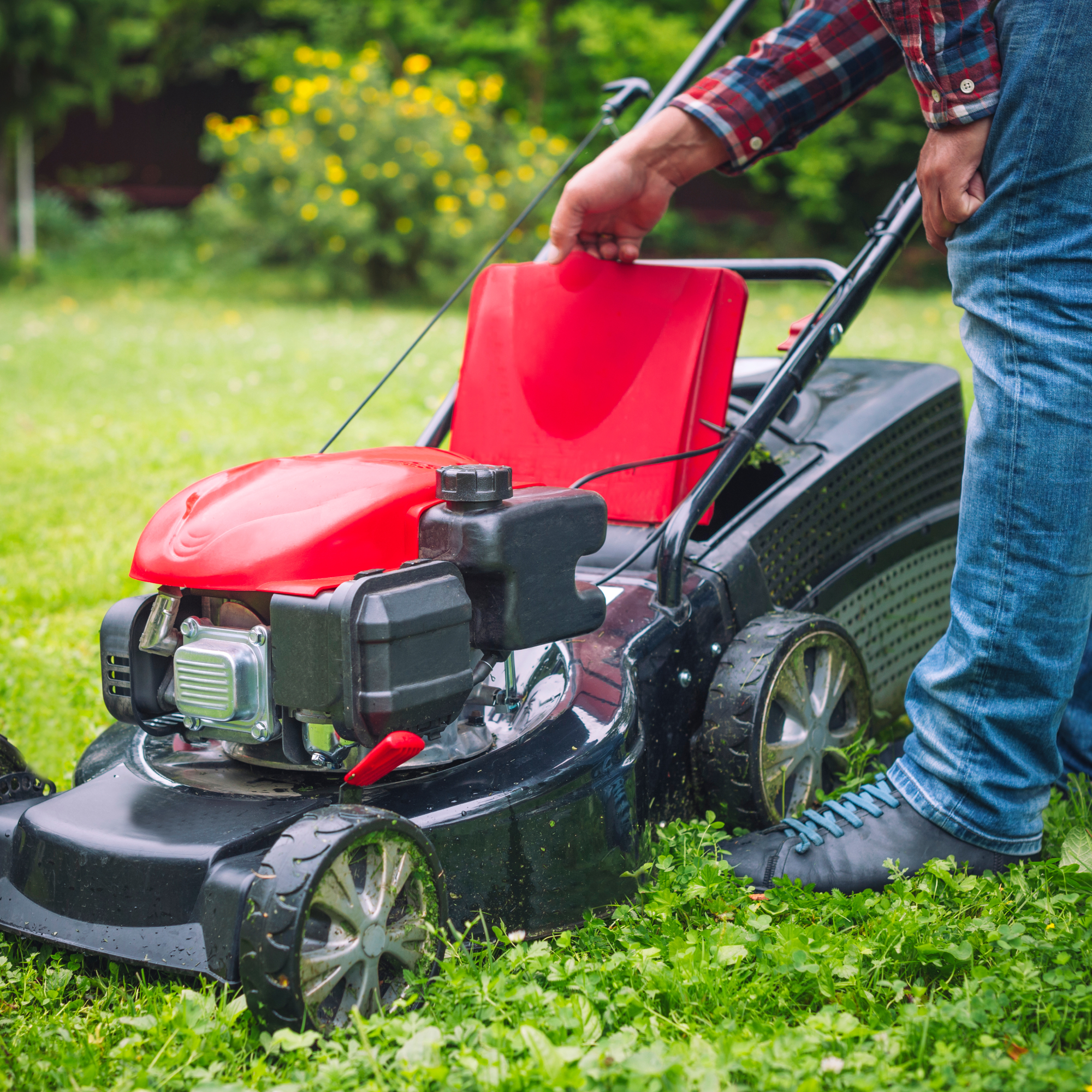man looking at lawn mower