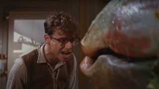 Rick Moranis sings angrily with Audrey II in Little Shop of Horrors.
