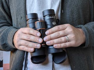 Jase Parnell-Brookes holding the Celestron regal ed 10x42 binoculars in their hands