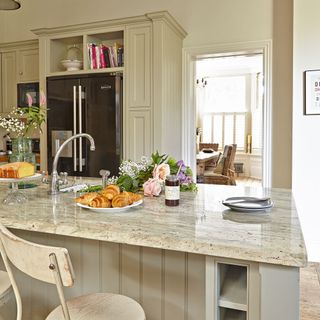 kitchen with marble worktop and flower bouquets