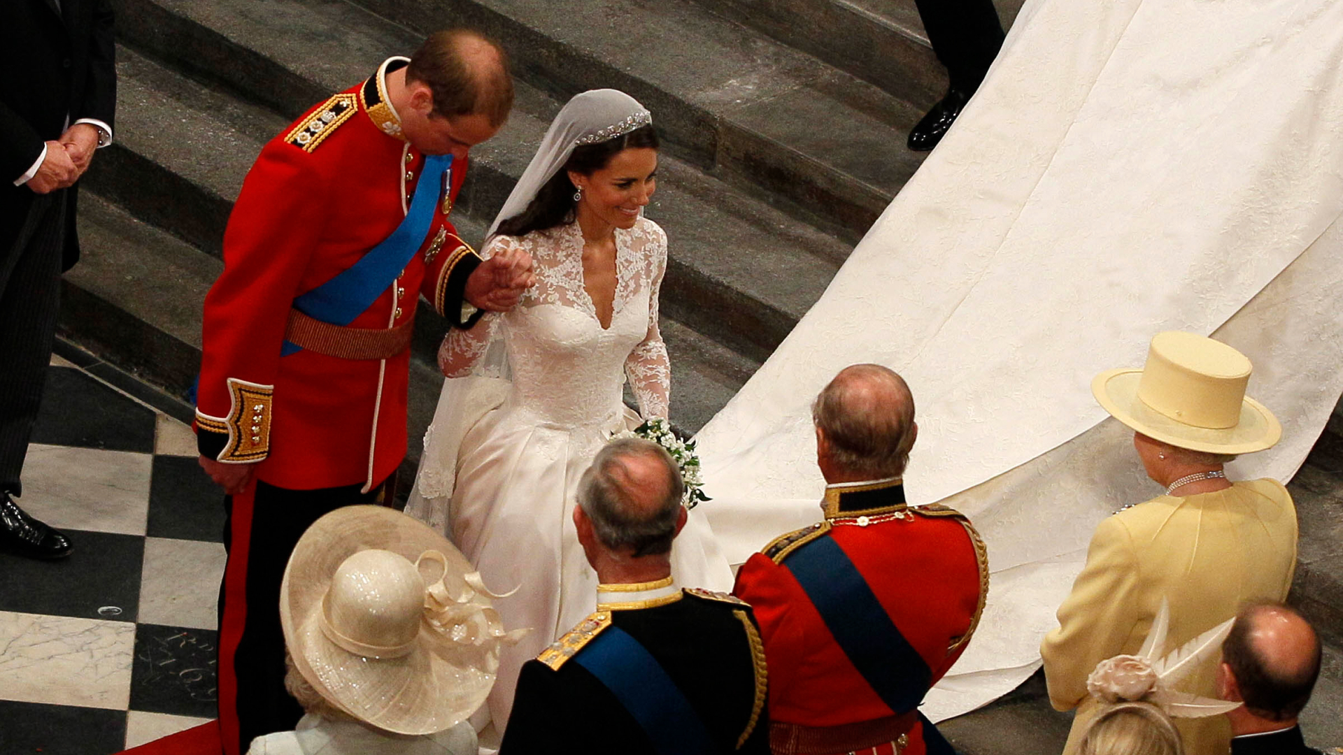Prince William bowing and Kate Middleton curtsying to Queen Elizabeth at their wedding