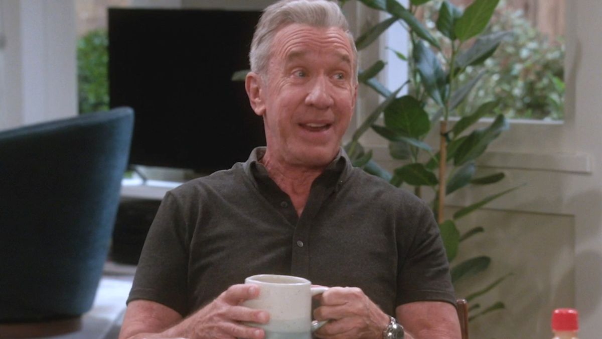 Tim Allen smiles in conversation as he holds a cup of coffee at the breakfast table in Shifting Gears.