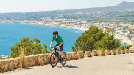 The best endurance road bike being ridden on a climb overlooking the coast