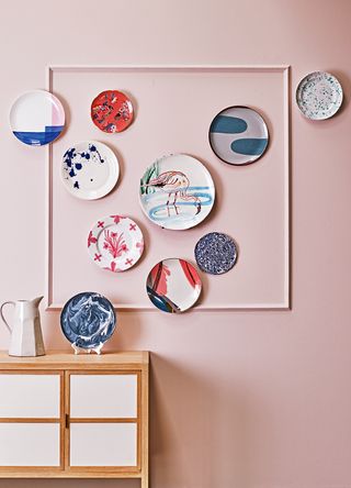 Pink wall with decorative plate hanging as wallart