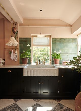 Pink kitchen with black cabinetry by deVOL