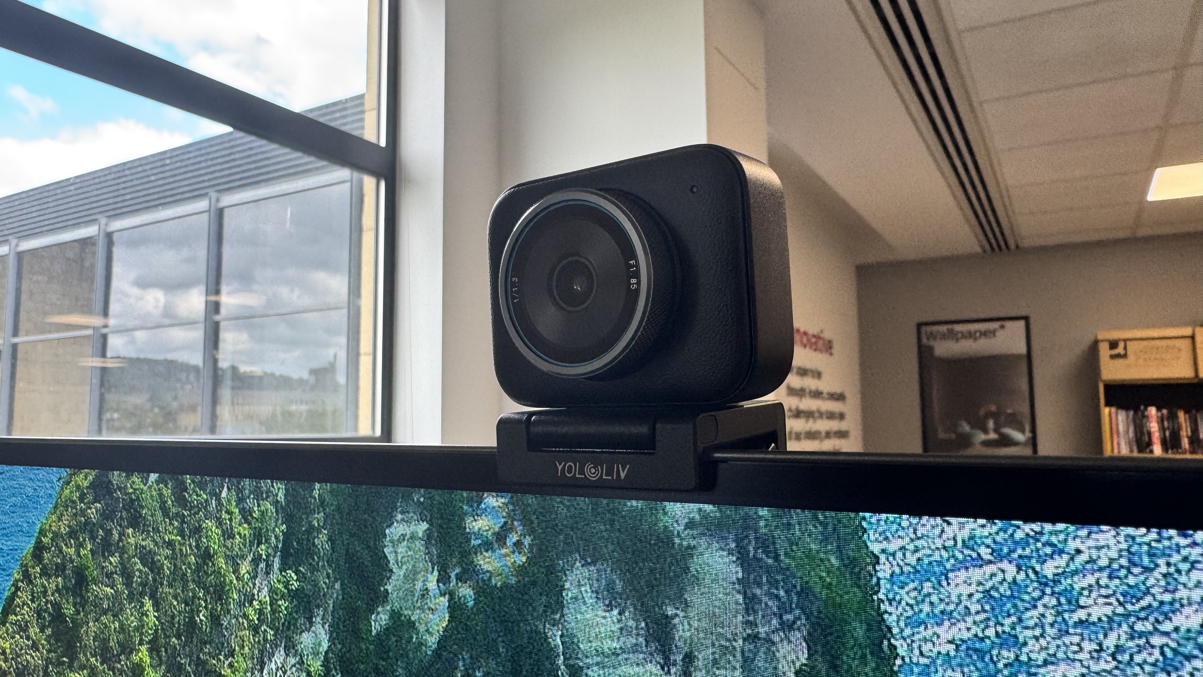 The Yololiv YoloCam S3 4K webcam from the front right, on top of a monitor