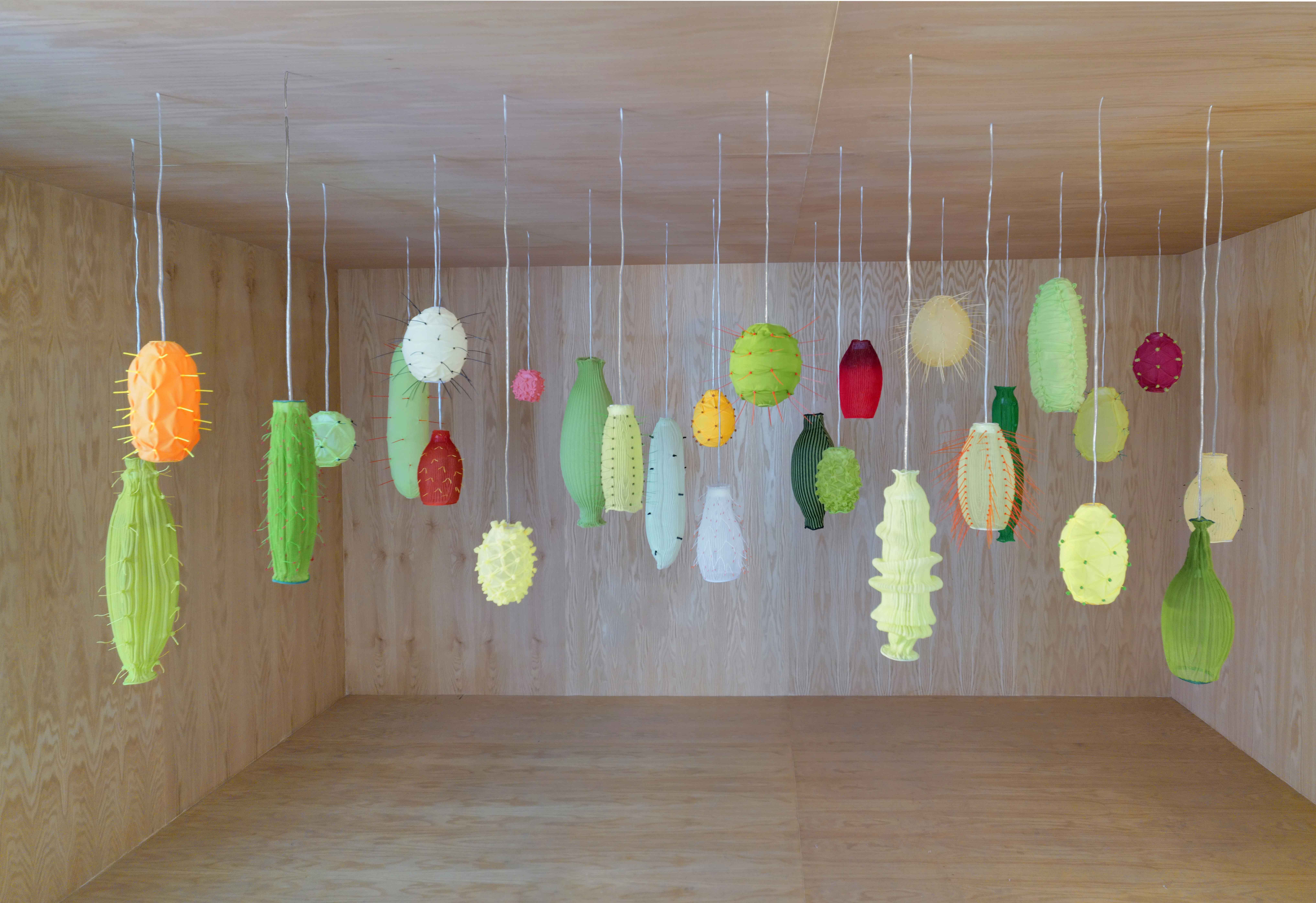 Cactus-shaped pendant lamps in a wooden room