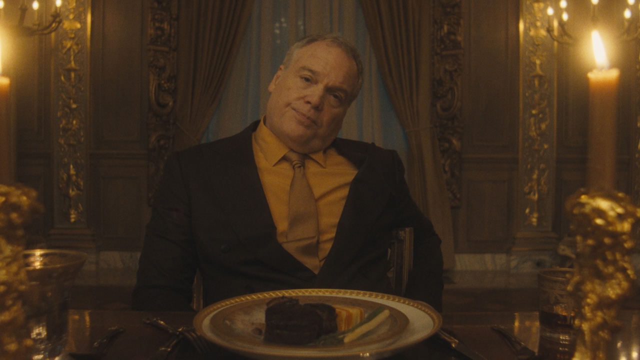 Vincent D'Onofrio's Byron Frost with head cocked at the dinner table in The Beauty Season 1