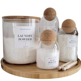 4 glass jars with cork lids designed for laundry organisation 