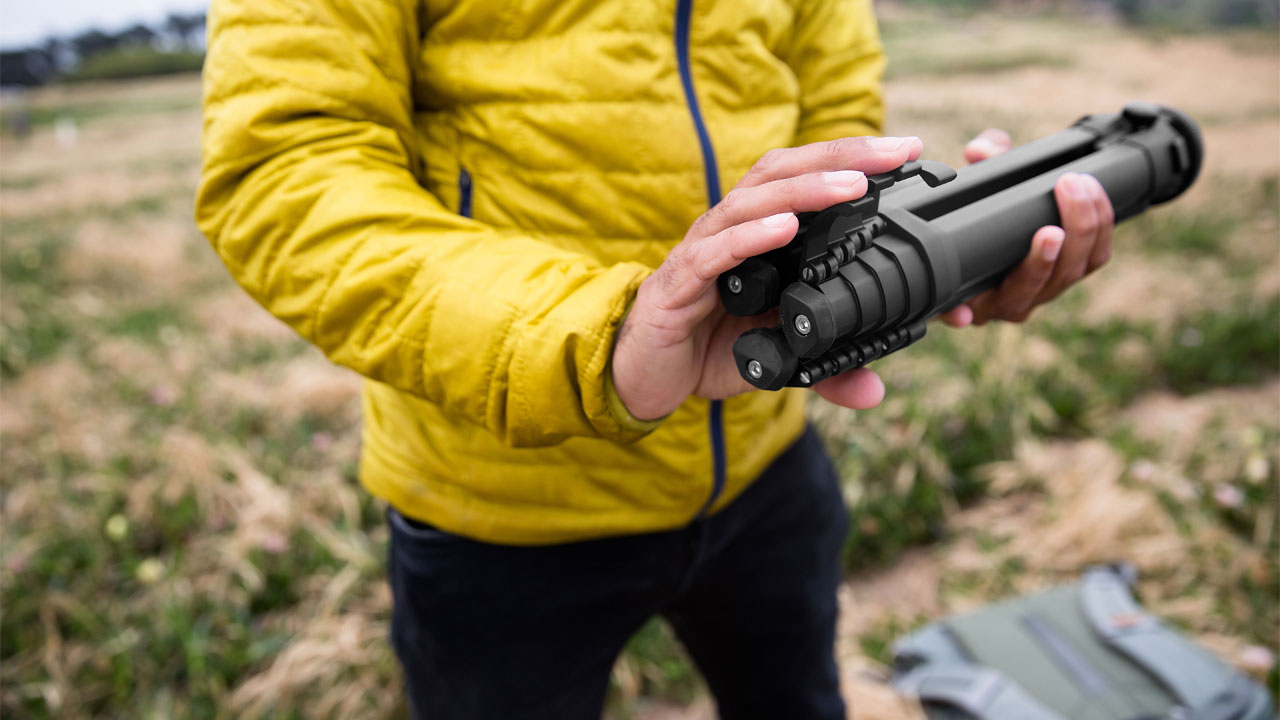 Peak Design Travel Tripod Review: image shows man holding a camera tripod