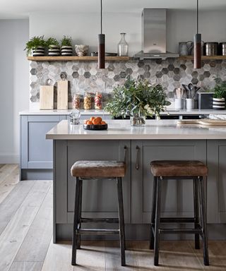 Kitchen with hexagon tiles and natural leather bar stools