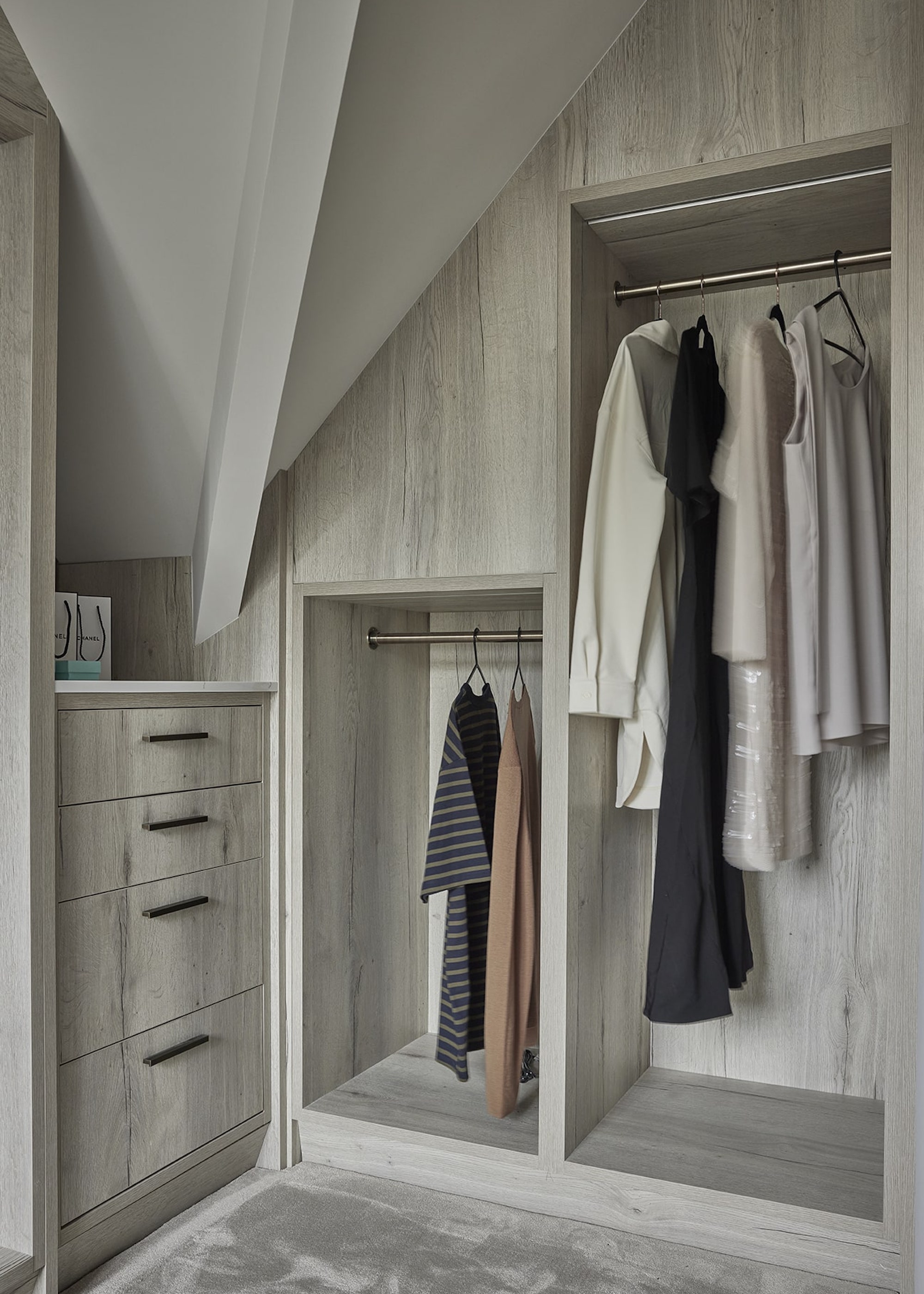 loft with built in open wardrobes finished in a grey wood effect