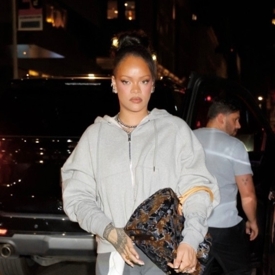 Rihanna wears gray sweats paired with a sold-out Louis Vuitton emblem bag covered in velvet and sequins