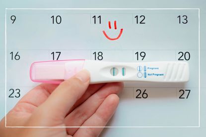 Hand holding a test to illustrate ovulation calculator