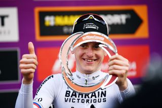 SANREMO ITALY MARCH 19 Matej Mohoric of Slovenia and Team Bahrain Victorious holds up his trophy and celebrates winning the race on the podium ceremony after the 113th MilanoSanremo 2022 a 293km one day race from Milano to Sanremo MilanoSanremo on March 19 2022 in Sanremo Italy Photo by Tim de WaeleGetty Images