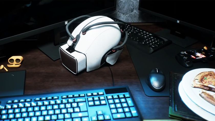 A first-person view of a desk with a virtual reality headset resting above a keyboard and next to a leftover piece of pizza