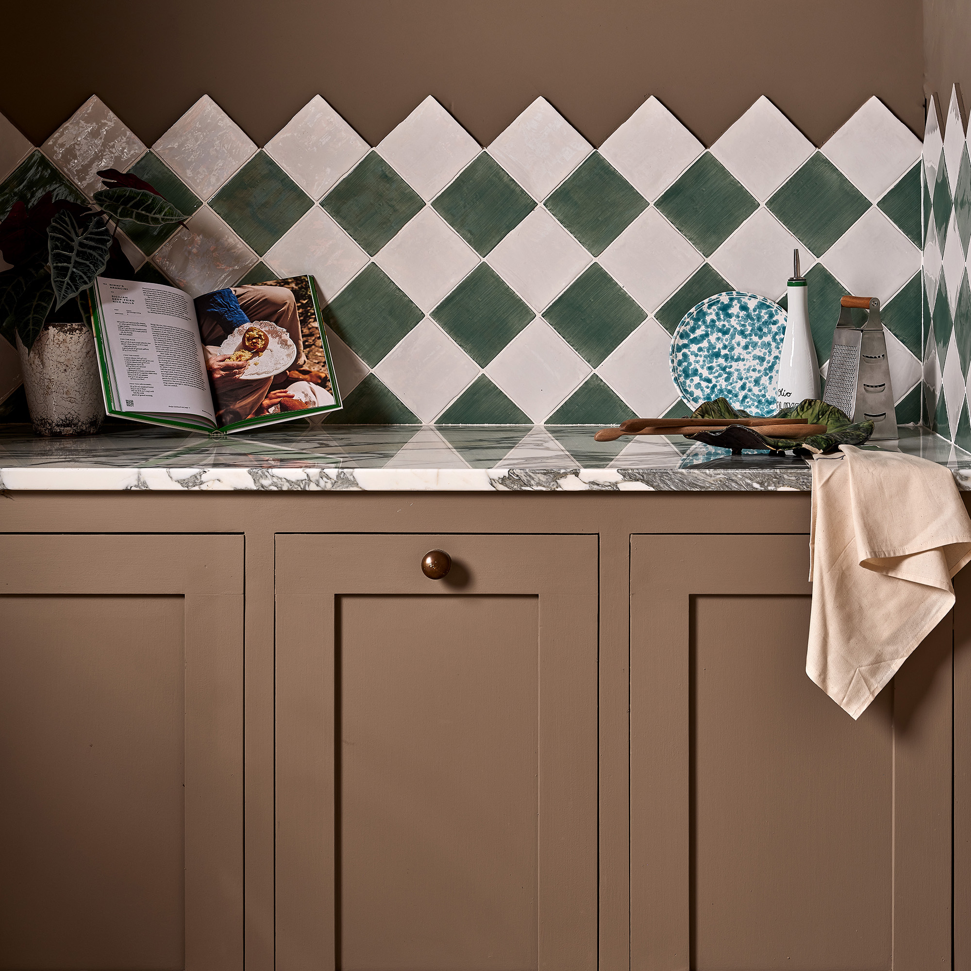 Khaki kitchen with checkerboard tiles on backsplash