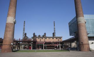 A former power plant featuring two large, brick chimneys
