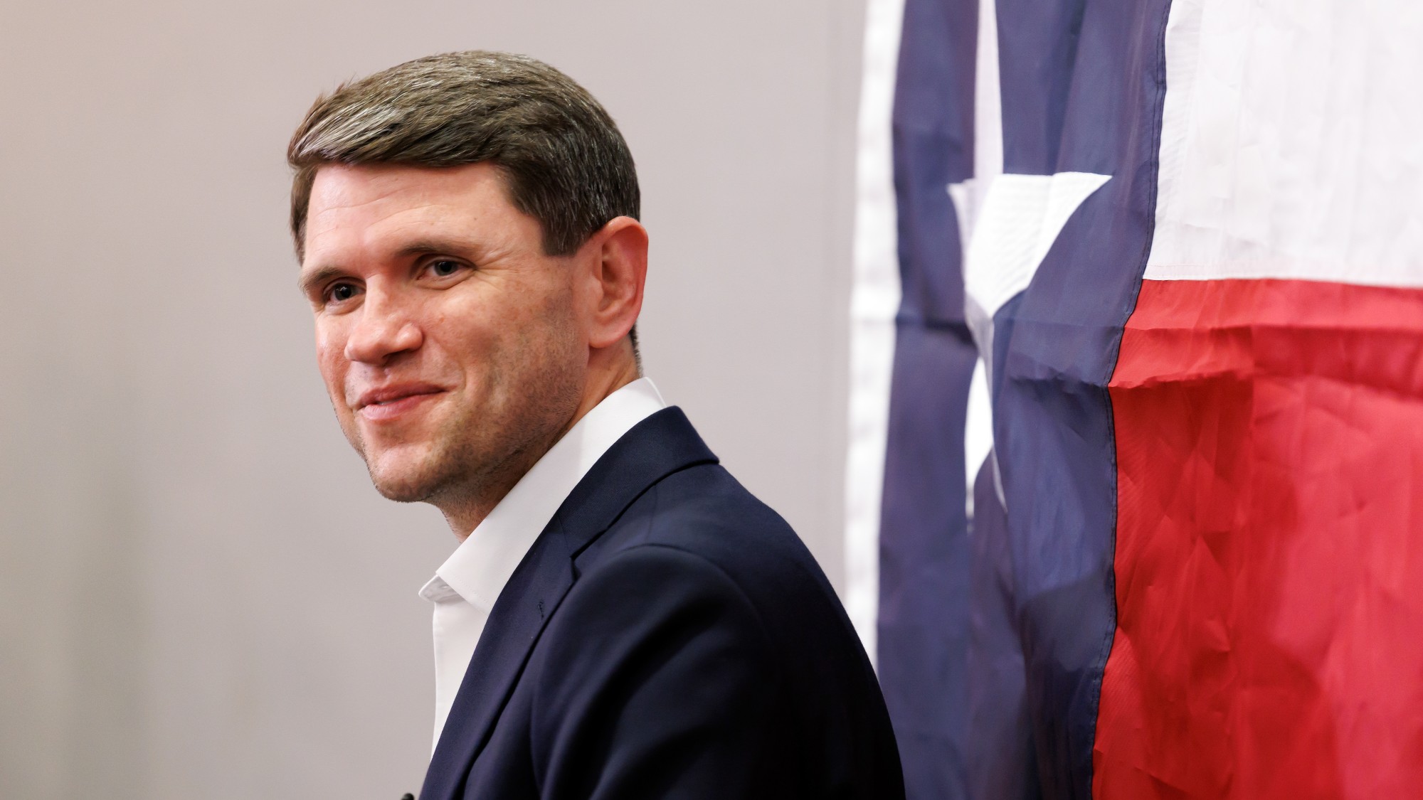 James Talarico, in front of a Texas state flag