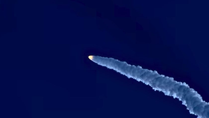 view of rocket flying through a blue sky