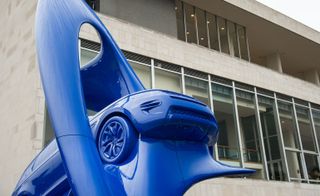 Giant blue art sculpture of land drover